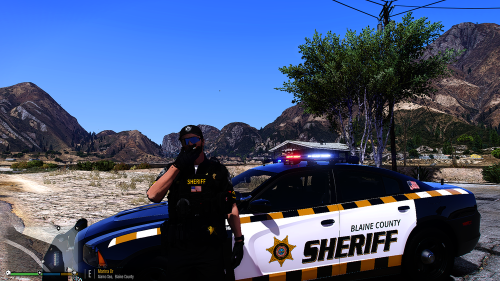 Could contain: outdoor, vehicle, land vehicle, tire, wheel, motorsport, transport, car, text, police, mountain, person