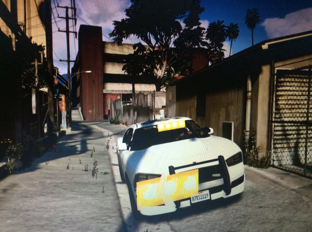 Could contain: outdoor, vehicle, land vehicle, building, car, sky, ground, road, street, parked, city, yellow