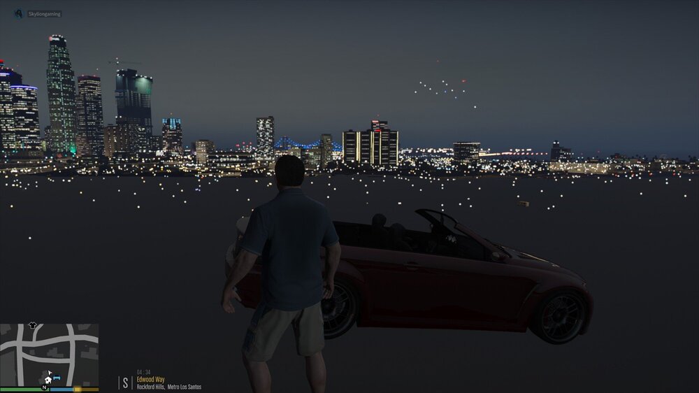 Could contain: car, skyscraper, vehicle, sky, outdoor, land vehicle, wheel, man, person, city, night