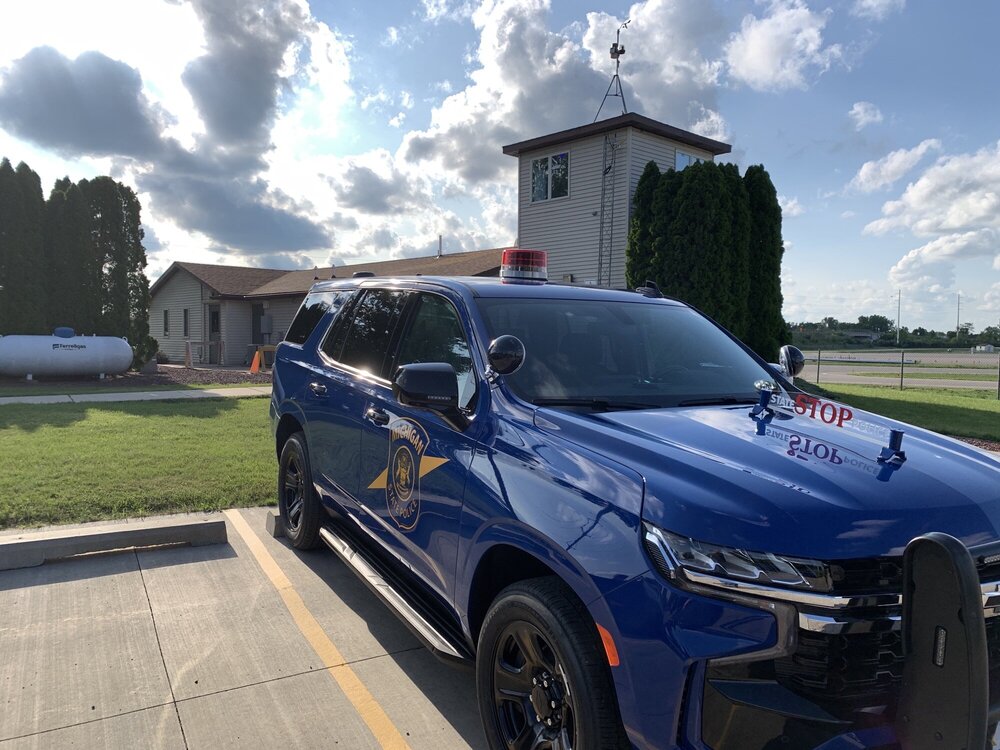 Could contain: sky, land vehicle, outdoor, vehicle, wheel, tire, automotive design, bumper, blue, automotive exterior, auto part, road, car, grass, parked, ground