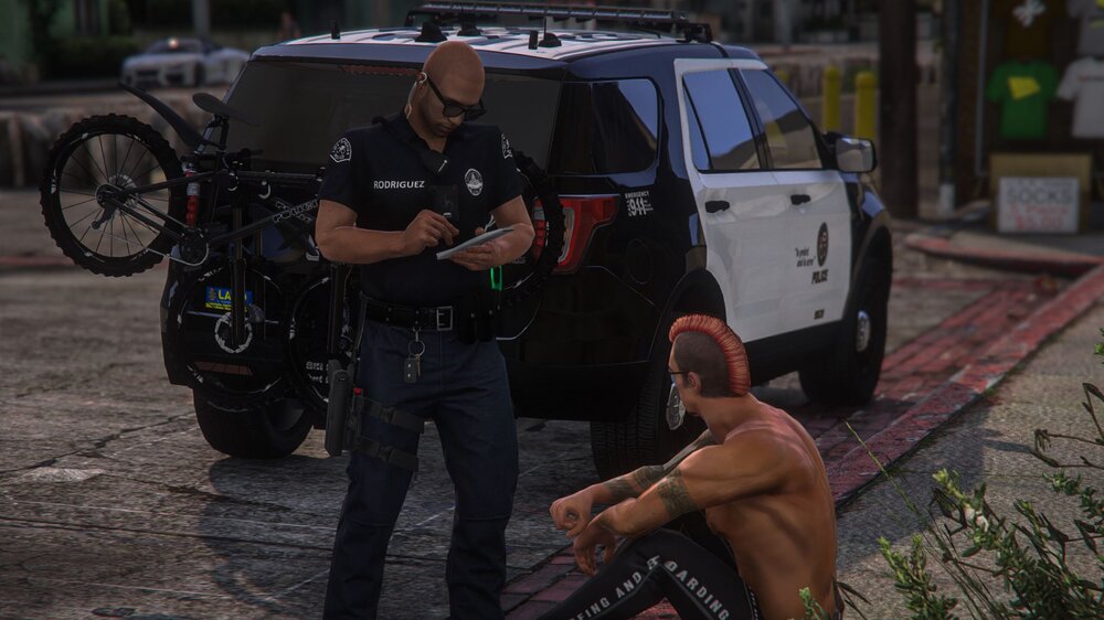 Could contain: wheel, tire, outdoor, land vehicle, vehicle, person, man, car, ground, clothing, auto part, police, dog, street