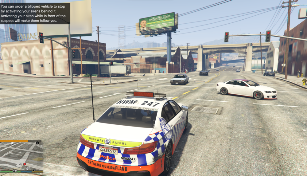 Could contain: text, land vehicle, vehicle, outdoor, wheel, transport, road, billboard, police car, vehicle registration plate, mode of transport, emergency service, emergency vehicle, car, street, police, ground