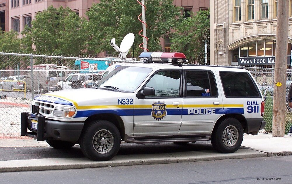 Could contain: vehicle, land vehicle, outdoor, transport, wheel, text, law enforcement, emergency vehicle, emergency service, police car, police, ford, car, tire, police van, emergency, vehicle registration plate, street