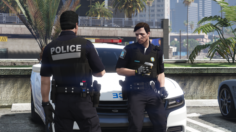 Could contain: clothing, person, vehicle, outdoor, car, man, land vehicle, wheel, officer, police, tire, law enforcement, text, trousers, building, police officer