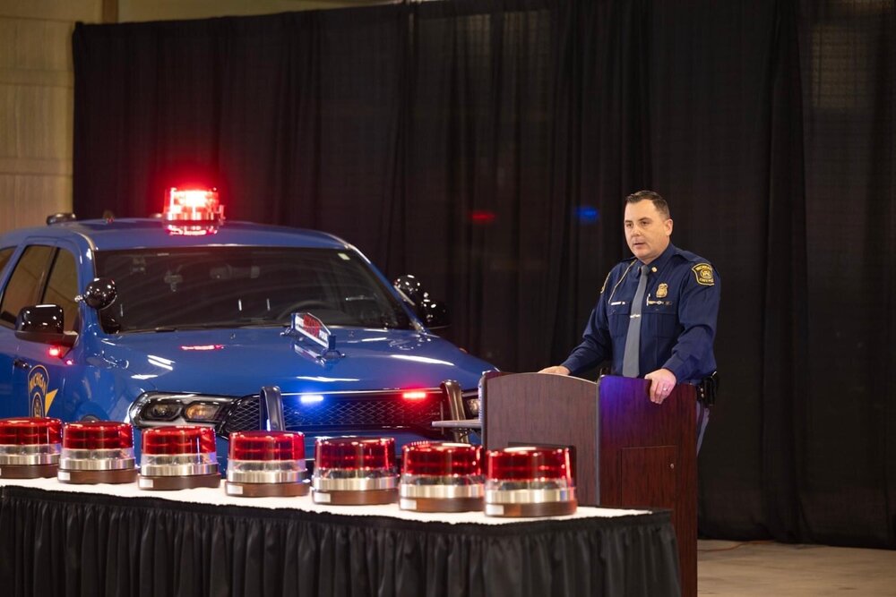 Could contain: vehicle, land vehicle, clothing, person, wheel, indoor, red, standing, blue, car