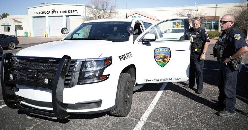 Could contain: vehicle, land vehicle, outdoor, wheel, tire, bumper, man, clothing, person, automotive exterior, motor vehicle, car, police, parked, ground