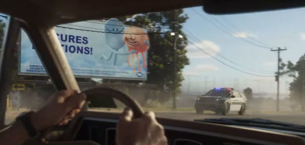 Could contain: outdoor, sky, car, land vehicle, mirror, windshield, automotive mirror, rear-view mirror, auto part, person, text, street, driving, vehicle, road