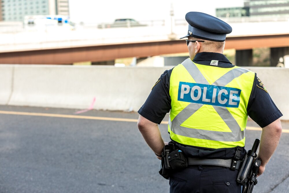 Could contain: clothing, person, outdoor, helmet, police officer, law enforcement, building, police, man, security, road, officer, street, city, wearing