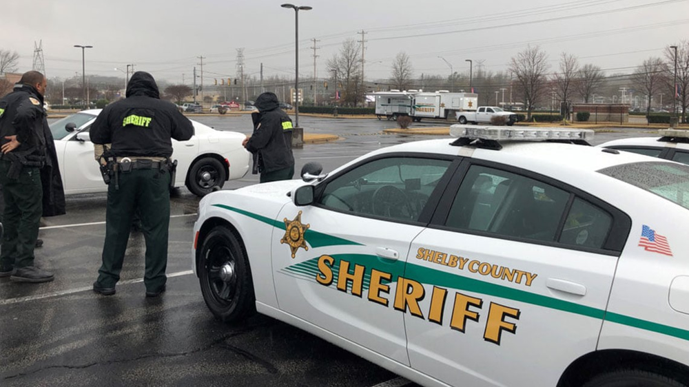 Could contain: vehicle, land vehicle, wheel, transport, outdoor, text, law enforcement, tire, sky, full-size car, police car, car, mid-size car, clothing, sports sedan, person, police