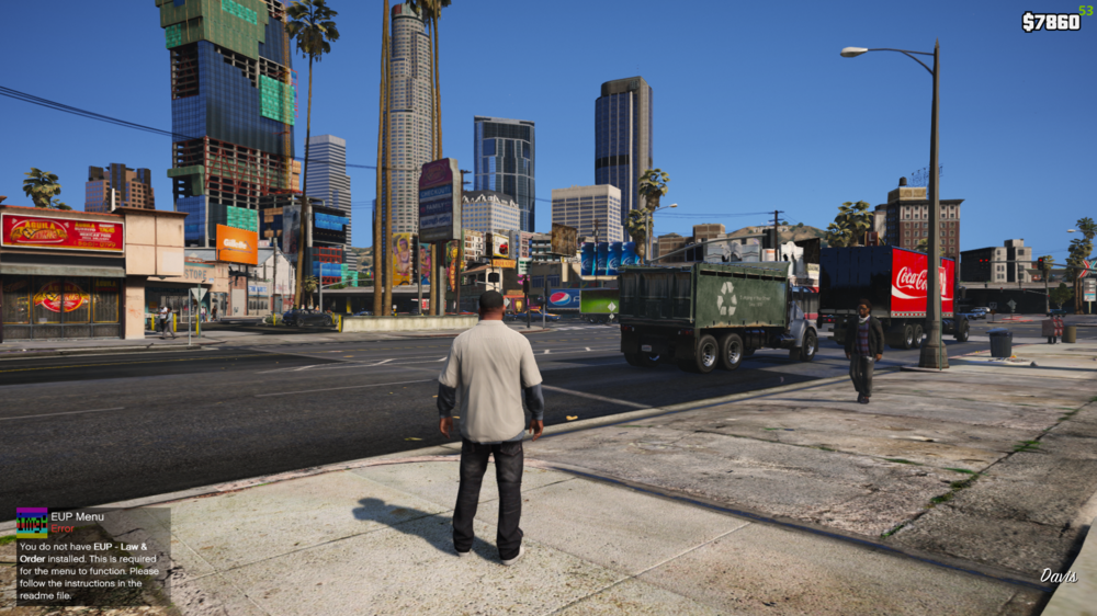 Could contain: sky, outdoor, clothing, footwear, man, billboard, skyscraper, screenshot, person, street, ground, city, downtown