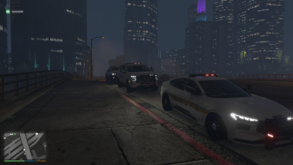 Could contain: vehicle, land vehicle, wheel, building, skyscraper, outdoor, city, road, car, light, night, ground