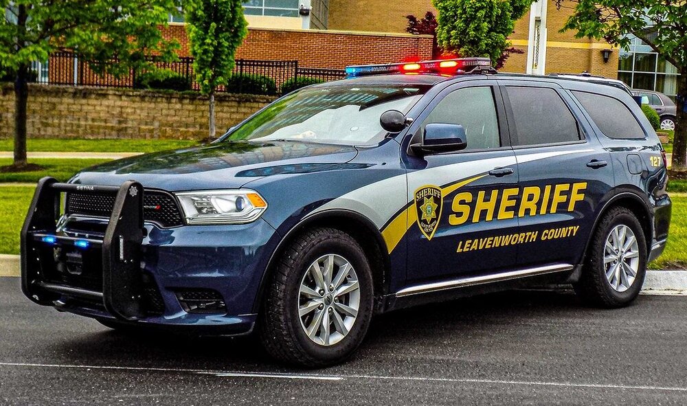 Could contain: vehicle, land vehicle, wheel, text, transport, outdoor, tire, police car, law enforcement, police, vehicle registration plate, full-size car, ford, car, auto part, bumper, ford motor company, automotive light bulb, street