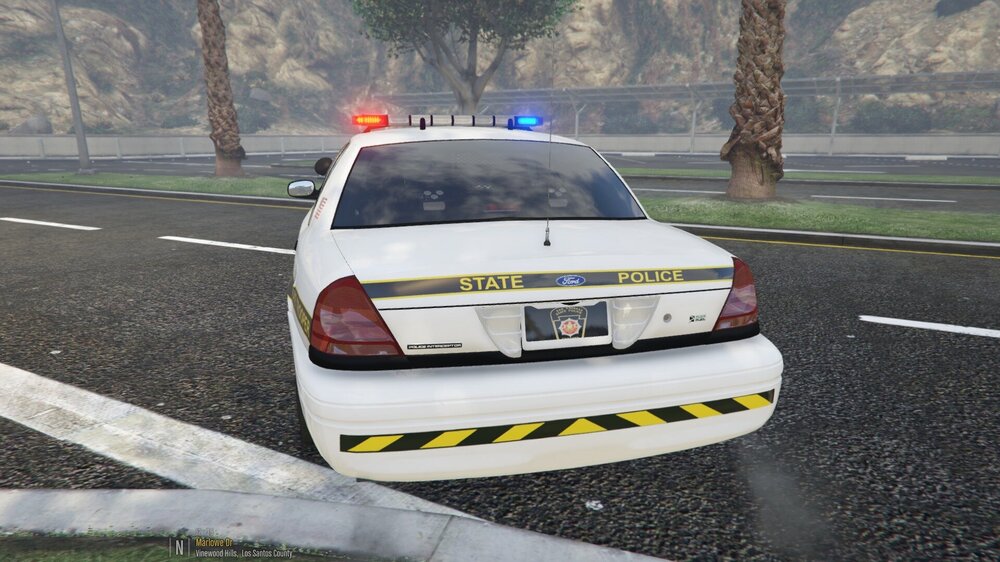 Could contain: vehicle, land vehicle, outdoor, wheel, text, emergency service, emergency vehicle, road, vehicle registration plate, car, emergency, police, police car, law enforcement, transport, full-size car, street