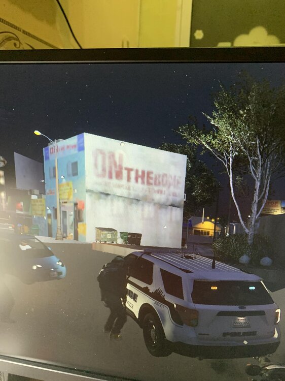 Could contain: vehicle, text, land vehicle, wheel, outdoor, car, billboard, auto part, tire, street, night