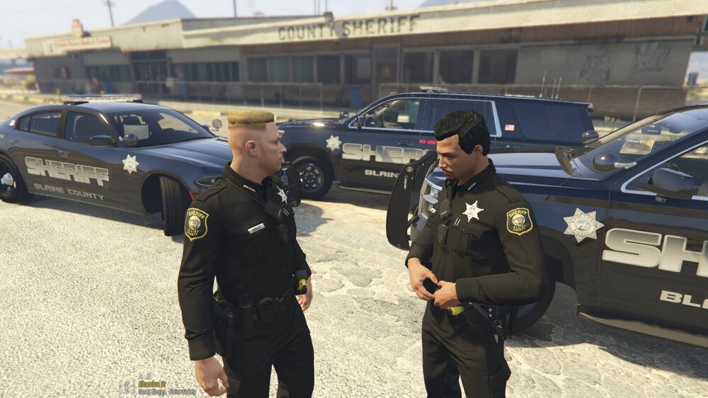 Could contain: vehicle, land vehicle, clothing, outdoor, person, man, law enforcement, wheel, security, police officer, police, tire, government agency, official, officer, full-size car, car, ground, uniform