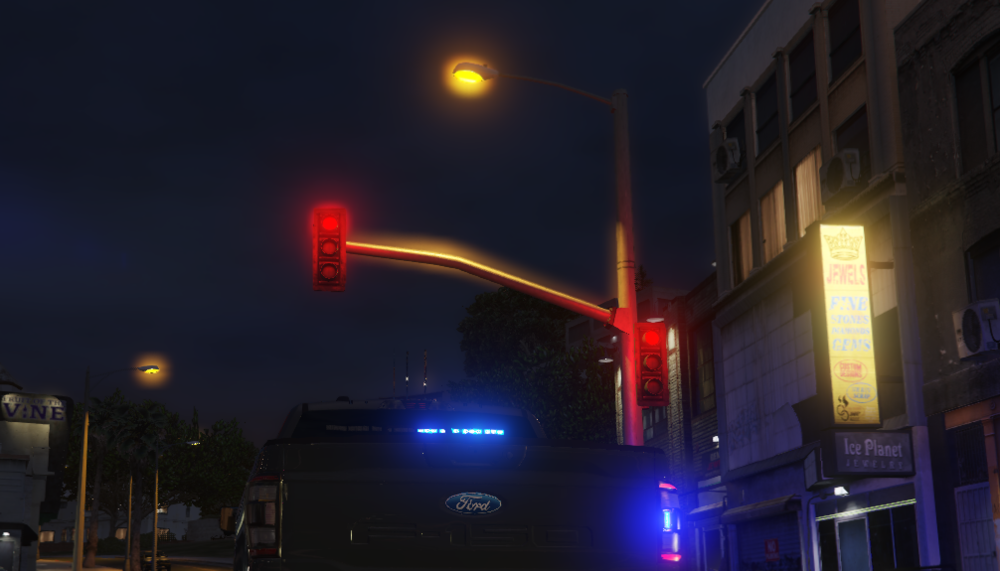 Could contain: outdoor, light, street light, sky, land vehicle, vehicle, night, electricity, signaling device, building, street, security lighting, traffic light, lighting, car, traffic, road, city, dark, red