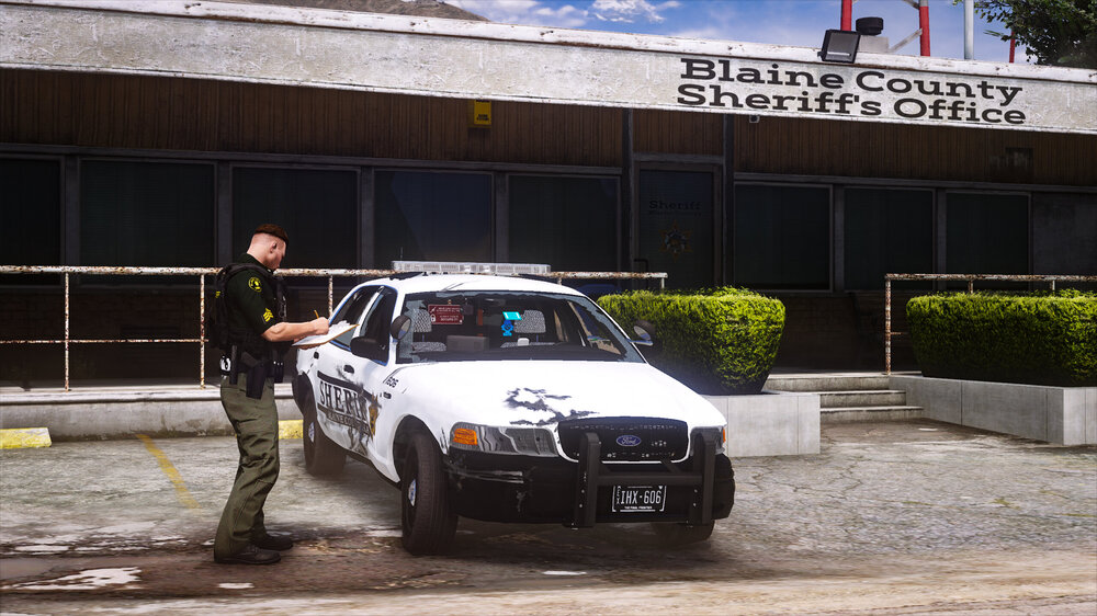 Could contain: vehicle, land vehicle, outdoor, wheel, building, tire, text, transport, motorsport, ground, automotive exterior, automotive tire, car, person, police, parked