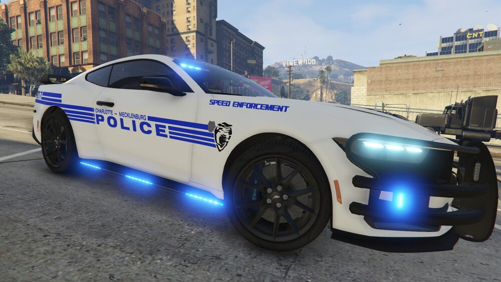 Could contain: vehicle, land vehicle, wheel, tire, police car, text, transport, outdoor, auto part, law enforcement, full-size car, mid-size car, sports sedan, automotive design, automotive light bulb, car, police