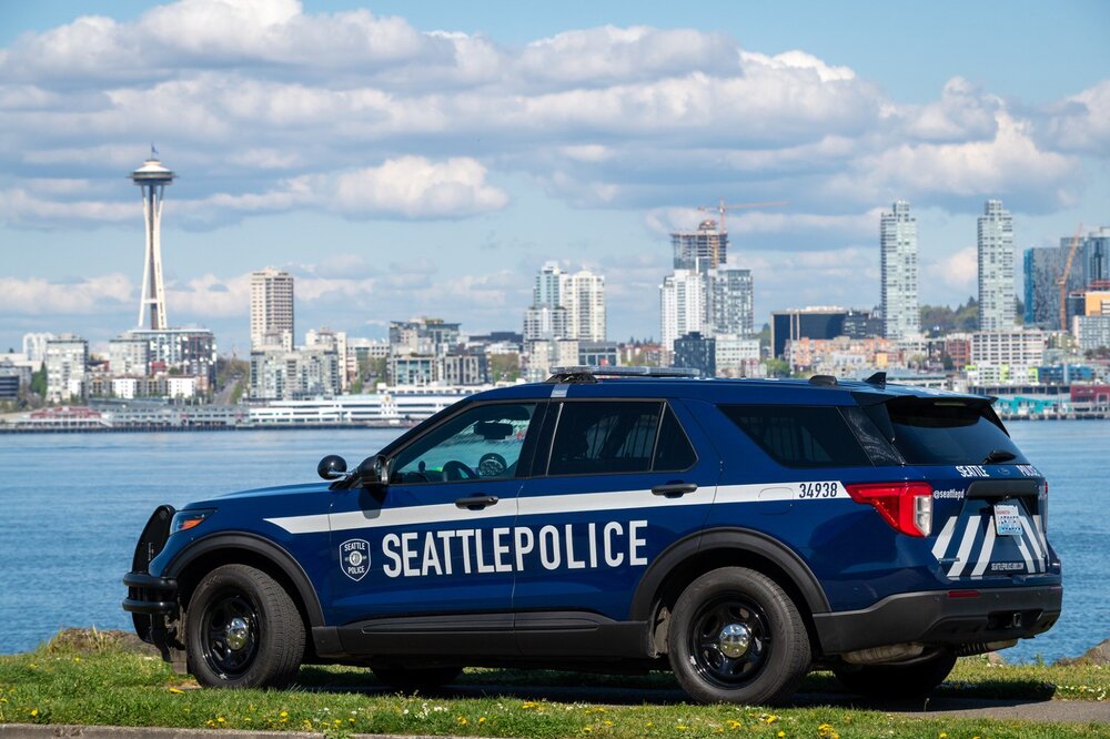 Could contain: vehicle, land vehicle, wheel, outdoor, sky, tire, transport, text, car, sport utility vehicle, compact sport utility vehicle, bumper, police car, crossover suv, ford, auto part, automotive exterior, cloud, police, blue, parked, city, suv