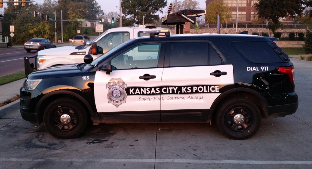 Could contain: vehicle, land vehicle, wheel, tire, outdoor, text, transport, auto part, sport utility vehicle, motor vehicle, police, car, automotive exterior, compact sport utility vehicle, vehicle registration plate, fender, bumper, ford, roof rack, automotive luggage rack, police car, road, street, parked