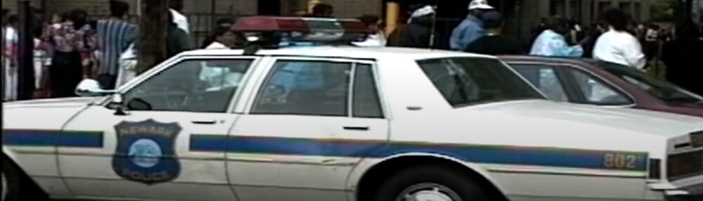 Could contain: vehicle, land vehicle, transport, car, wheel, outdoor, sedan, full-size car, law enforcement, hardtop, ford crown victoria police interceptor, vehicle door, automotive exterior, police, police car, motor vehicle, person, parked