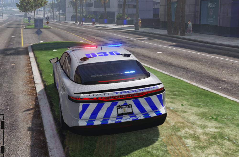 Could contain: vehicle, land vehicle, outdoor, text, car, road, mode of transport, police car, grass, wheel, emergency vehicle, emergency service, transport, street, police, driving, city