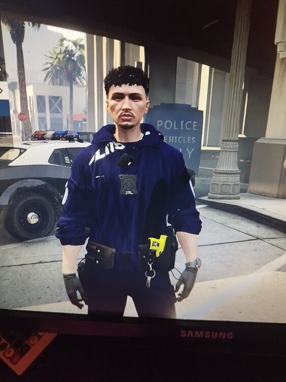 Could contain: clothing, person, human face, man, tire, building, vehicle, wheel, smile, ground, posing, standing, uniform, outdoor, wearing, work-clothing