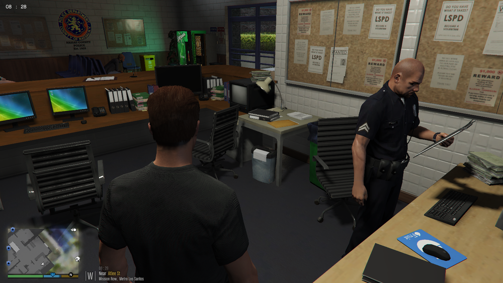 Could contain: indoor, clothing, text, person, table, desk, furniture, computer, man, computer monitor, office building, wall