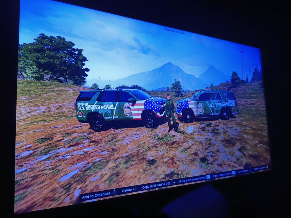 Could contain: land vehicle, vehicle, text, sky, outdoor, display device, screenshot, video, wheel, mountain, television