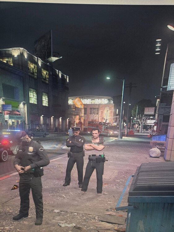 Could contain: clothing, building, ground, man, outdoor, firefighter, person, footwear, screenshot, vehicle, billboard, people, city, street