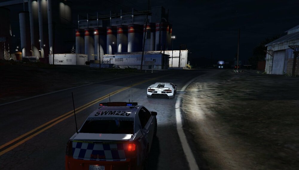 Could contain: vehicle, land vehicle, outdoor, car, wheel, road, transport, motorsport, street, driving, police, night