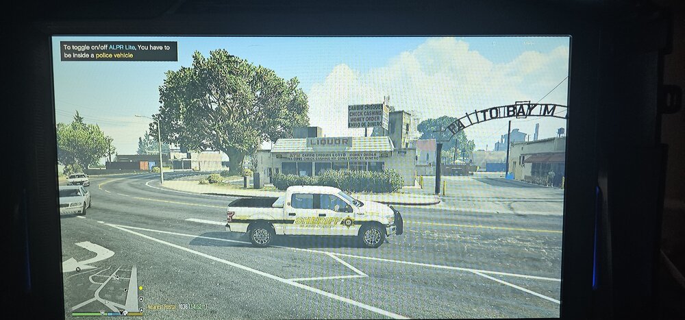 Could contain: text, vehicle, land vehicle, car, billboard, outdoor, sky, wheel, tree, street