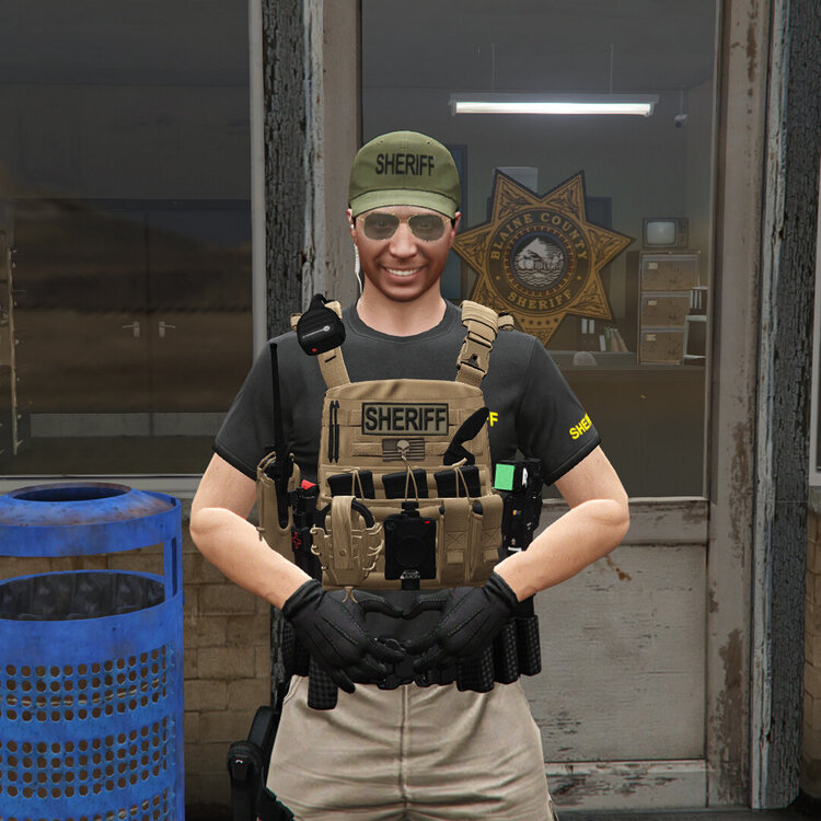 Could contain: clothing, person, human face, smile, waste container, building, man, fashion accessory, holding, standing