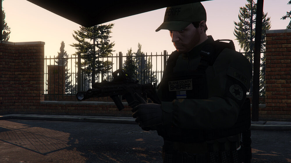 Could contain: clothing, person, sky, outdoor, weapon, building, man, tree, rifle, firearm, gun, security, ground, military uniform