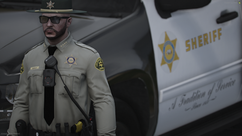 Could contain: clothing, person, man, vehicle, land vehicle, human face, car, law enforcement, security, outdoor, officer, police, wearing