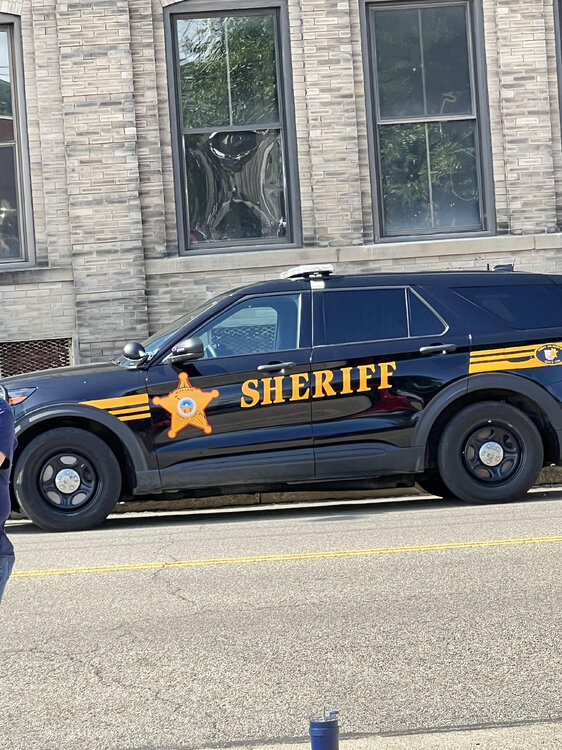 Could contain: vehicle, land vehicle, wheel, text, outdoor, transport, tire, building, car, auto part, law enforcement, window, street, police, van