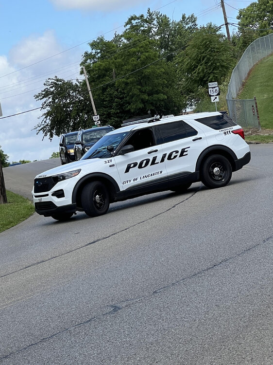 Could contain: outdoor, vehicle, land vehicle, wheel, sky, transport, road, tire, police car, car, police, text