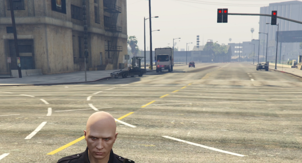 Could contain: outdoor, person, street, road, human face, sky, clothing, man, building, traffic light, glasses, way, city, light, ground, wearing