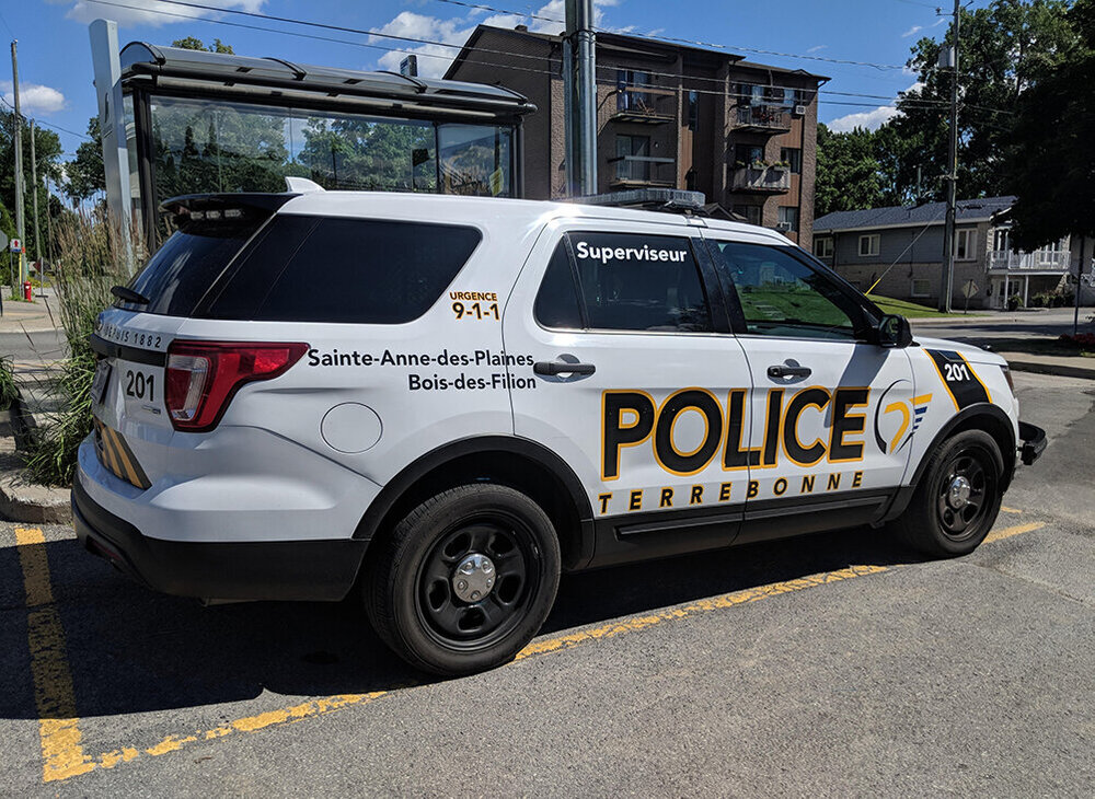 Could contain: land vehicle, vehicle, text, outdoor, wheel, transport, sky, tire, police, vehicle registration plate, motor vehicle, sport utility vehicle, auto part, compact sport utility vehicle, ford, automotive exterior, bumper, police car, road, crossover suv, minivan, parked, car, street