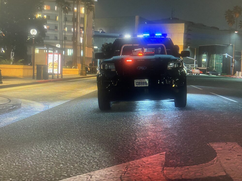 Could contain: land vehicle, vehicle, outdoor, text, road, wheel, street, car, building, automotive lighting, vehicle registration plate, automotive tail & brake light, auto part, traffic light, traffic, city, ground, night, way, light, driving