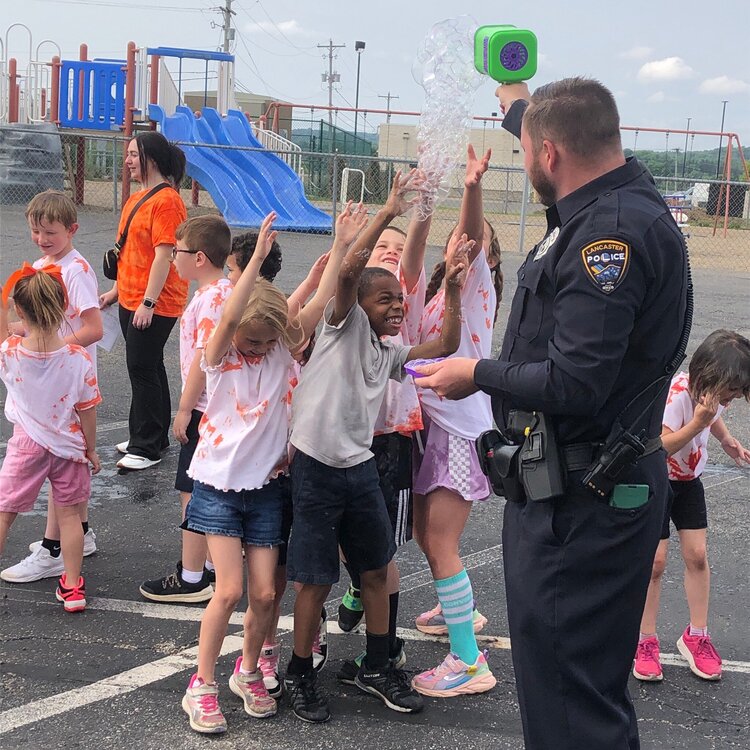 Could contain: clothing, footwear, person, outdoor, boy, ground, girl, group, shorts, sky, man, toddler, people, standing