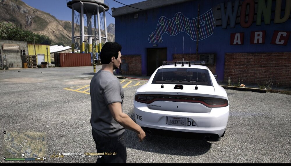 Could contain: vehicle, outdoor, land vehicle, person, clothing, wheel, ground, tire, car, building, auto part, road, sky, mountain