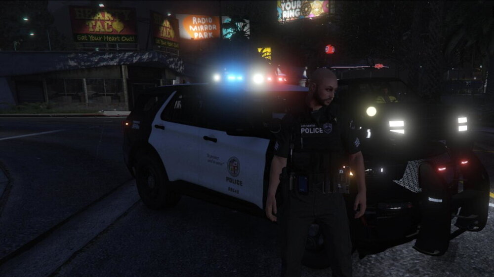 Could contain: vehicle, land vehicle, wheel, tire, outdoor, auto part, road, transport, automotive lighting, light, person, street, car, police, officer, night