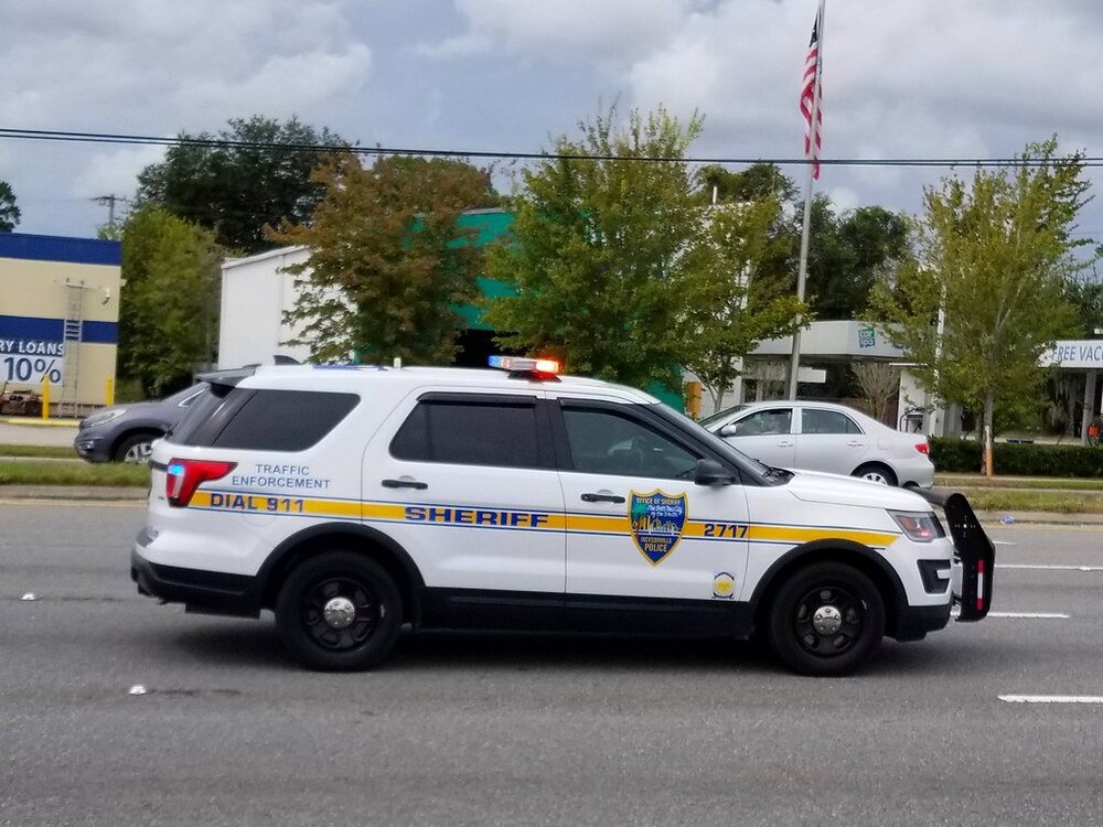 Could contain: vehicle, land vehicle, outdoor, wheel, transport, law enforcement, sky, police car, emergency vehicle, emergency service, car, text, emergency, ford, police van, tire, motor vehicle, full-size car, automotive exterior, road, police, street