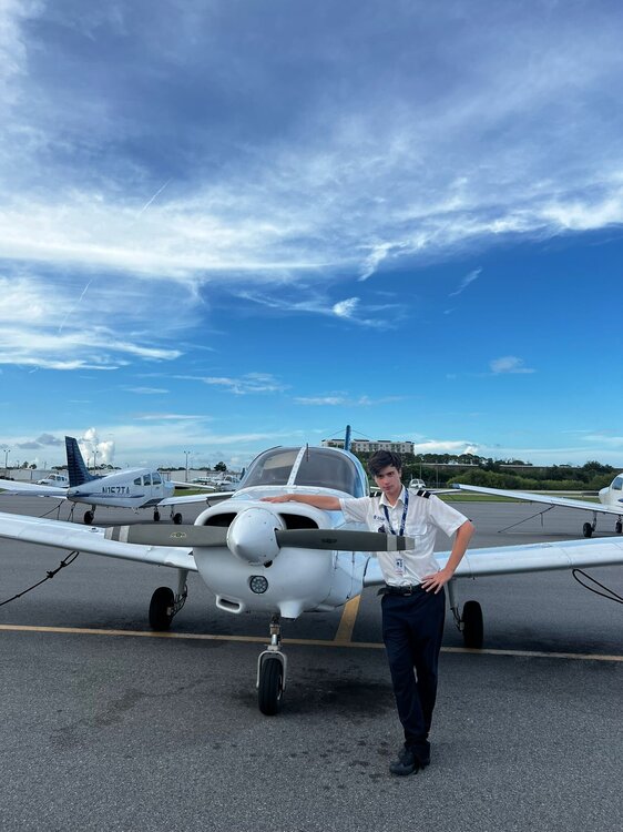 Could contain: transport, sky, outdoor, aircraft, plane, vehicle, airplane, ground, general aviation, monoplane, air travel, cloud, propeller-driven aircraft, aviation, light aircraft, propeller, aerospace manufacturer, person, turboprop, airshow, parked, runway, standing