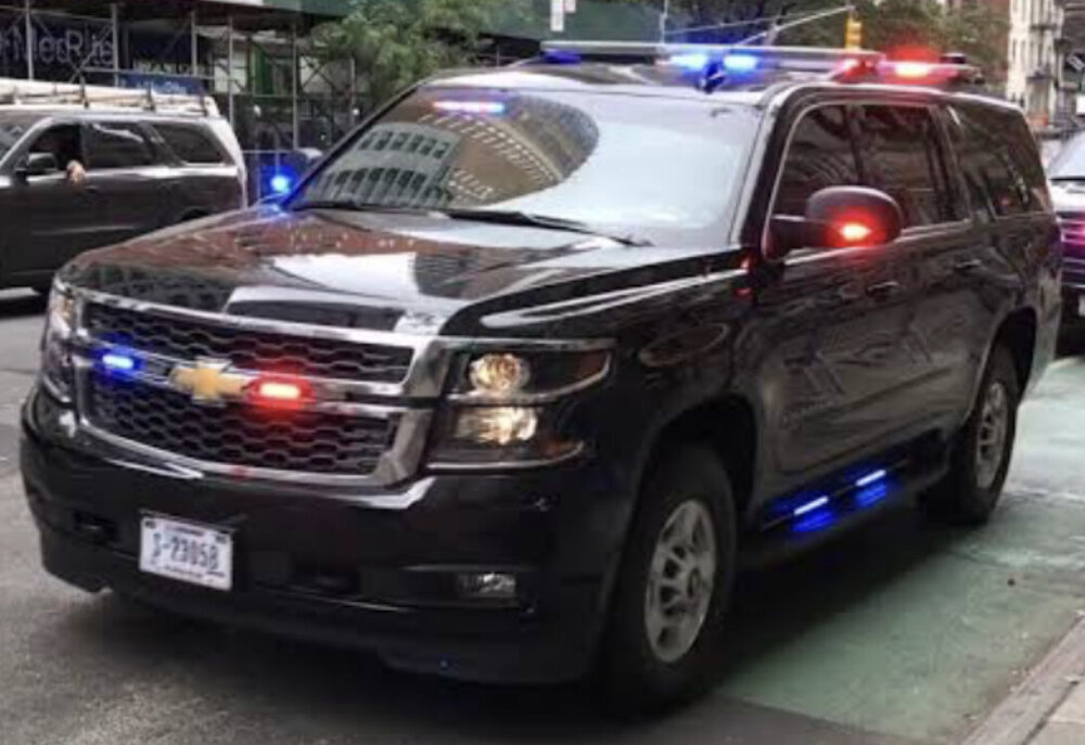 Could contain: land vehicle, vehicle, wheel, transport, tire, bumper, auto part, vehicle registration plate, text, ford, emergency service, emergency vehicle, motor vehicle, outdoor, sport utility vehicle, automotive exterior, law enforcement, chevrolet, police car, general motors, compact sport utility vehicle, ford motor company, emergency, police, grille, full-size car, car, parked, van, suv