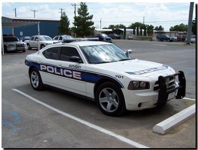 Could contain: vehicle, land vehicle, transport, wheel, car, outdoor, police car, full-size car, tire, law enforcement, sedan, automotive exterior, police, bumper, auto part, ford, ford crown victoria police interceptor, mid-size car, text, street