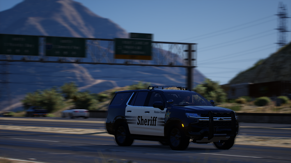 Could contain: vehicle, land vehicle, outdoor, wheel, tire, car, sky, road, motorsport, sport utility vehicle, auto part, transport, police, driving, blue, street, mountain