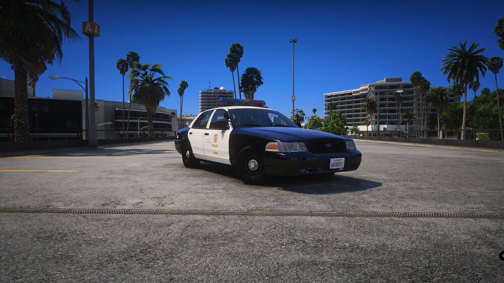 Could contain: vehicle, land vehicle, outdoor, sky, wheel, transport, car, tree, full-size car, road, sedan, mid-size car, ford crown victoria police interceptor, tire, police, ground, street