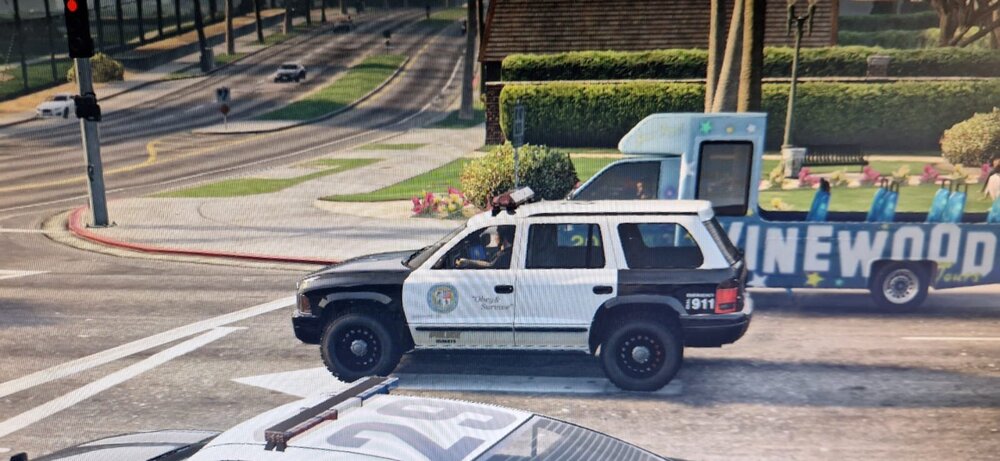 Could contain: vehicle, outdoor, land vehicle, wheel, tire, road, transport, auto part, ground, motor vehicle, fence, automotive tire, street, car, track, driving, police